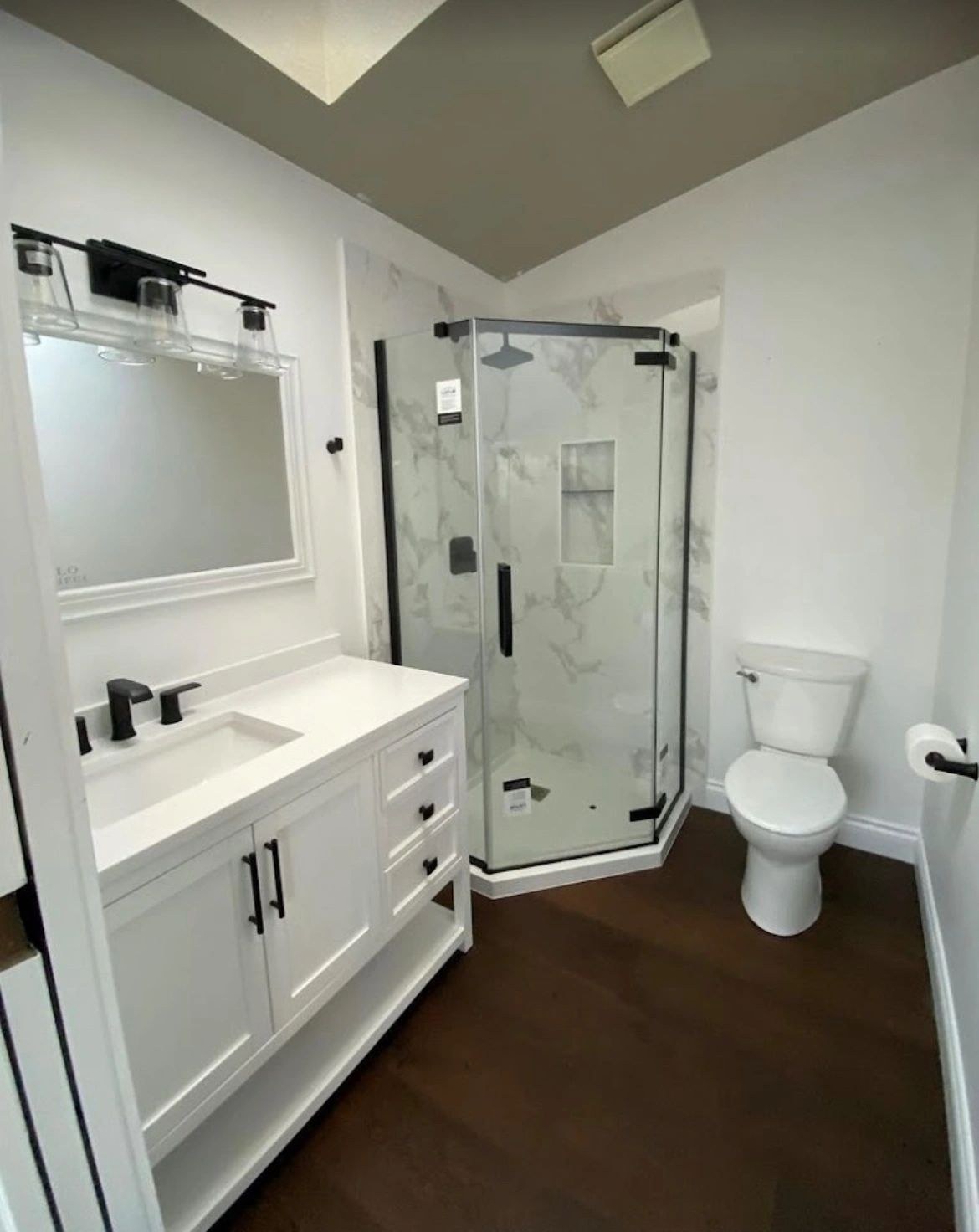 Finished bathroom with a glass shower and white vanity from Rapid Plumbing and Gas's gallery